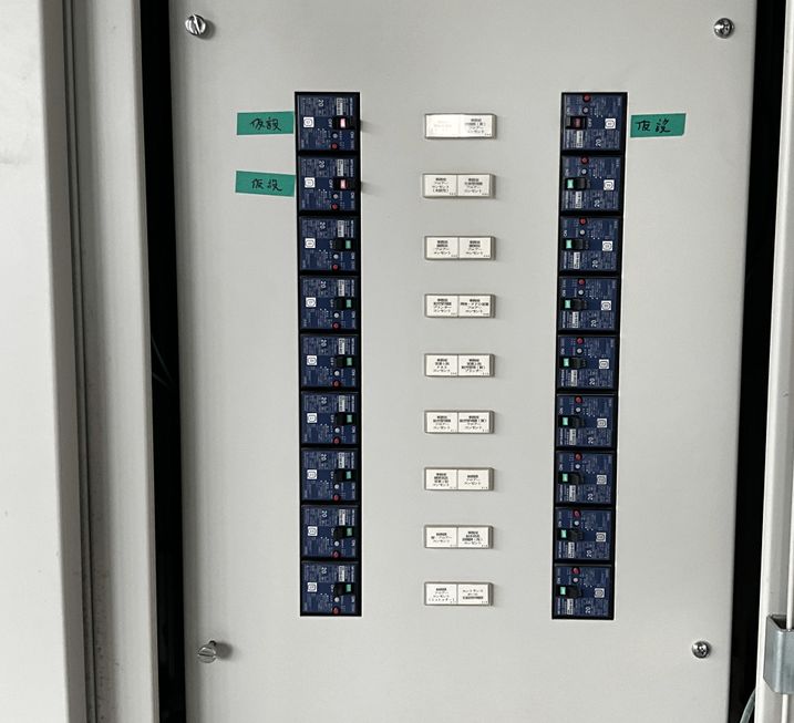 Breakers and circuit labels lined up inside the door of a distribution board